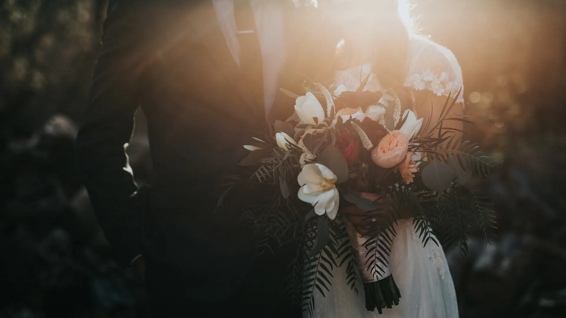 Ivory wedding dress detail with soft natural light and fabric texture.